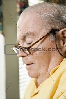 Senior Caucasian man with reading glasses.