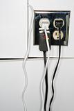 Electrical outlet with multiple plugs and cords.