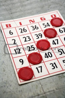 Red bingo card with winning chips.