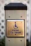 Metal door entrance button for handicapped people.