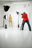Young female model being photographed  by male photographer.