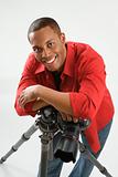 Young male adult photographer posing in studio.