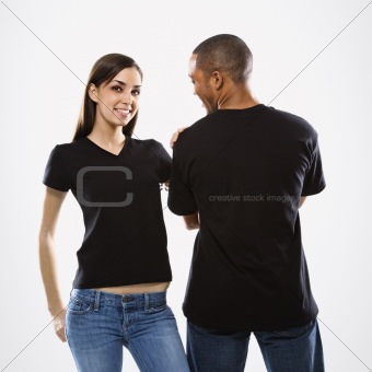 Teenage girl with hand on young male.