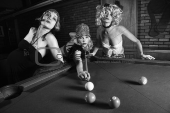 Three retro females shooting pool.
