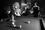 Retro male shooting pool with three retro females watching.