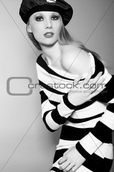 Girl in a striped jumper and a jeans cap.