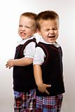 Caucasian twin boys crying.