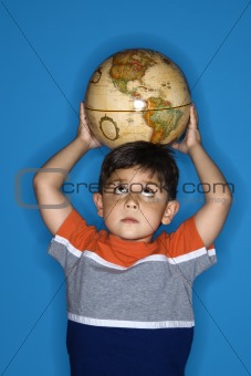Male boy holding globe on head.