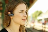 Young woman using bluetooth headset