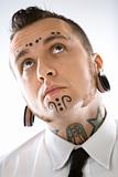 Adult male with tattoos and piercings.