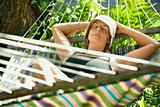 Woman relaxing in hammock.