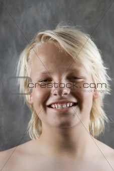 Male Caucasian adolescent smiling.