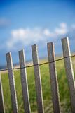 Weathered wooden fence on sand dune.