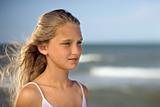 Girl on beach with ocean in background.