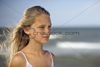 Girl on beach with ocean in background.