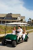 Family riding in golf cart.