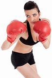 Sporty girl in boxing gloves punching