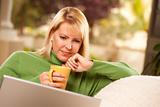 Beautiful, Smiling Woman Enjoys Her Warm Drink and Laptop Relaxing Day.