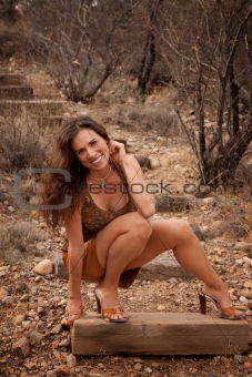 Portrait of pretty woman outdoors on wooden steps