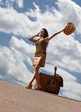 Pretty woman with suitcase and guitar