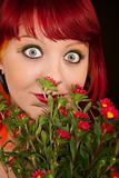 Pretty punky girl with brightly dyed red hair and flowers