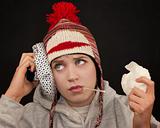 Sick young woman with thermometer and monkey cap