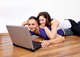 Youg couple at home with laptop
