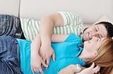 couple relax at home on sofa