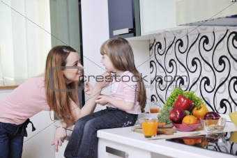 happy daughter and mom in kitchen