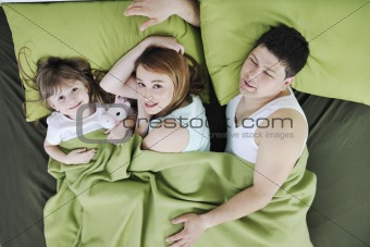 happy family relaxing in bed