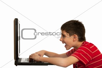 Kid is playing computer game on the laptop