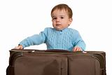 Confident toddler is packing a suitcase