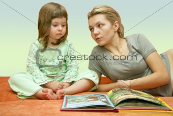 Mum reads a fairy tale to the child