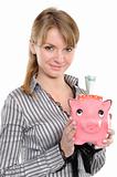Young woman putting money in piggy bank