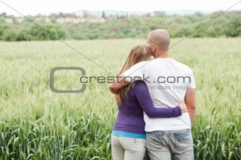 Rear view of couple with arms around each other