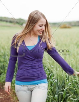 Woman walking beside the field
