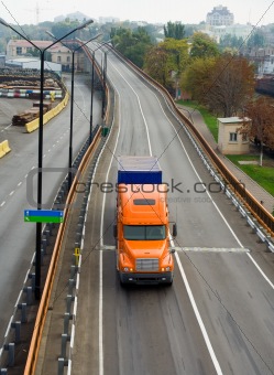 Orange truck on the road overpass