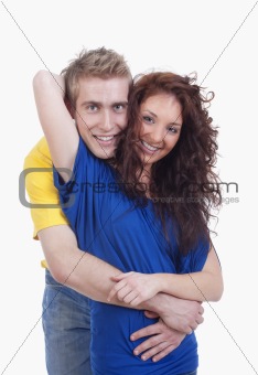 happy young couple - boy embracing girl, smiling - isolated on white