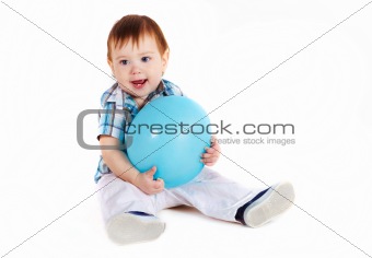 Child sitting with blue baloon