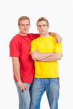 twin brothers standing looking at camera - isolated on white