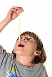 shot of a child eating pasta noodle