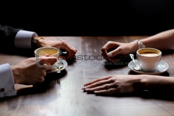 Bride's and groom's hands holding coffee cups