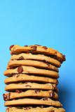 shot of chocolate chip cookie stack on blue vertical upclose