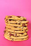 shot of chocolate chip cookie stack on pink vertical