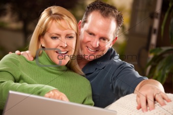 Handsome Happy Couple Using Their Laptop Together.