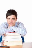 Young happy handsome male student leaning on study books