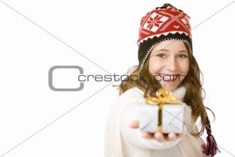 Young happy woman with cap is holding Christmas gift in hand
