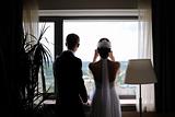 Bride and groom silhouettes against the window