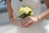 Bride's hands holding wedding bouquet