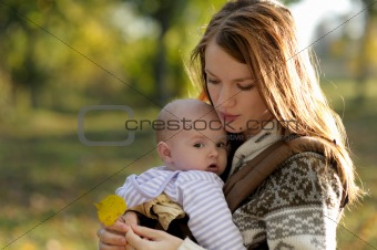 Young mother with her baby in a carrier